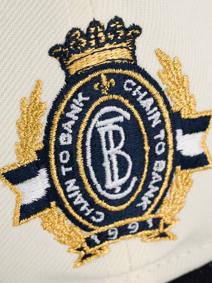 Chain To Bank Corona Laurea New Era RC 9Fifty Hat | CREAM/NAVY